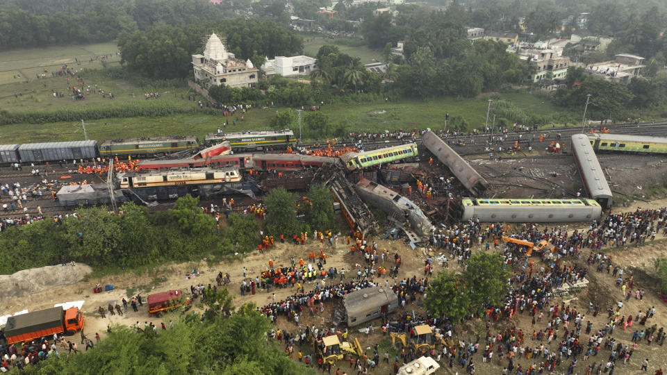 FILE - A drone shot of rescuers work at the site of passenger trains accident, in Balasore district, in the eastern Indian state of Orissa, Saturday, June 3, 2023. India’s federal crime agency Friday, July 7, 2023, said it has arrested three railway officials in connection with one of the country’s deadliest train accidents that killed more than 290 people people last month. (AP Photo/Arabinda Mahapatra, File)