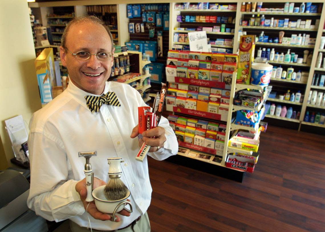 Las Olas Chemist is an old-style pharmacy in Fort Lauderdale. In this file photo from 2004, Marc Leach holds a shaving kit and some candy.