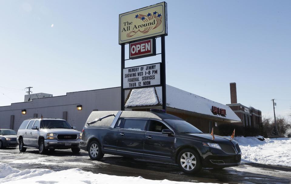 The hearse carrying Jimmy Lehr's casket leaves the All Around Bar in Taylor, Mich. on Thursday, Feb. 13, 2014. The suburban Detroit bar fulfilled the wish of their longtime employee who asked that his funeral be held at the watering hole where he worked for about 25 years. The 58-year-old died Feb. 7 after having pulmonary disease and congestive heart failure. A pine casket built at the bar was surrounded by flowers on the dance floor during a Wednesday wake. It's the same floor where Lehr's fourth wedding was held in 1996. (AP Photo/Carlos Osorio)