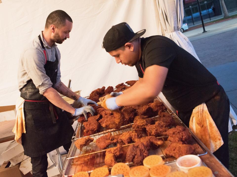 Two guys preparing Nashville Hote Chicken