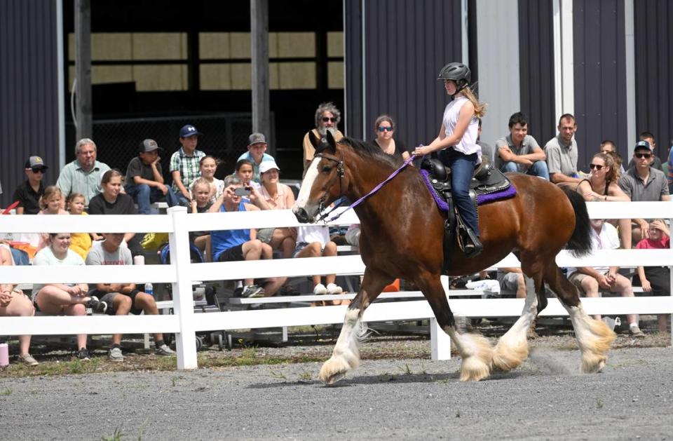 Mia Brokenshire, 12, rides 5-year-old Clydesdale Grace during a draft horse demonstration by Spring Mount Percherons at Penn State’s Ag Progress Days on Tuesday, Aug. 9, 2022.