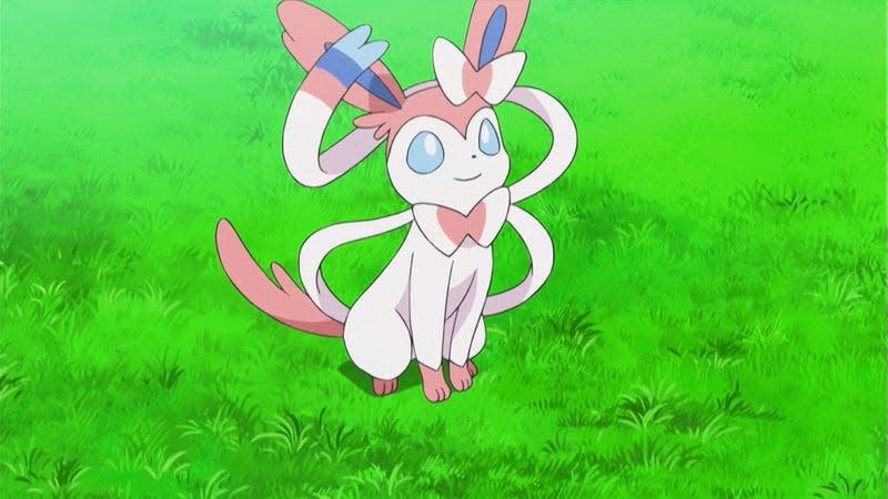 Sylveon is seen sitting in a patch of grass.