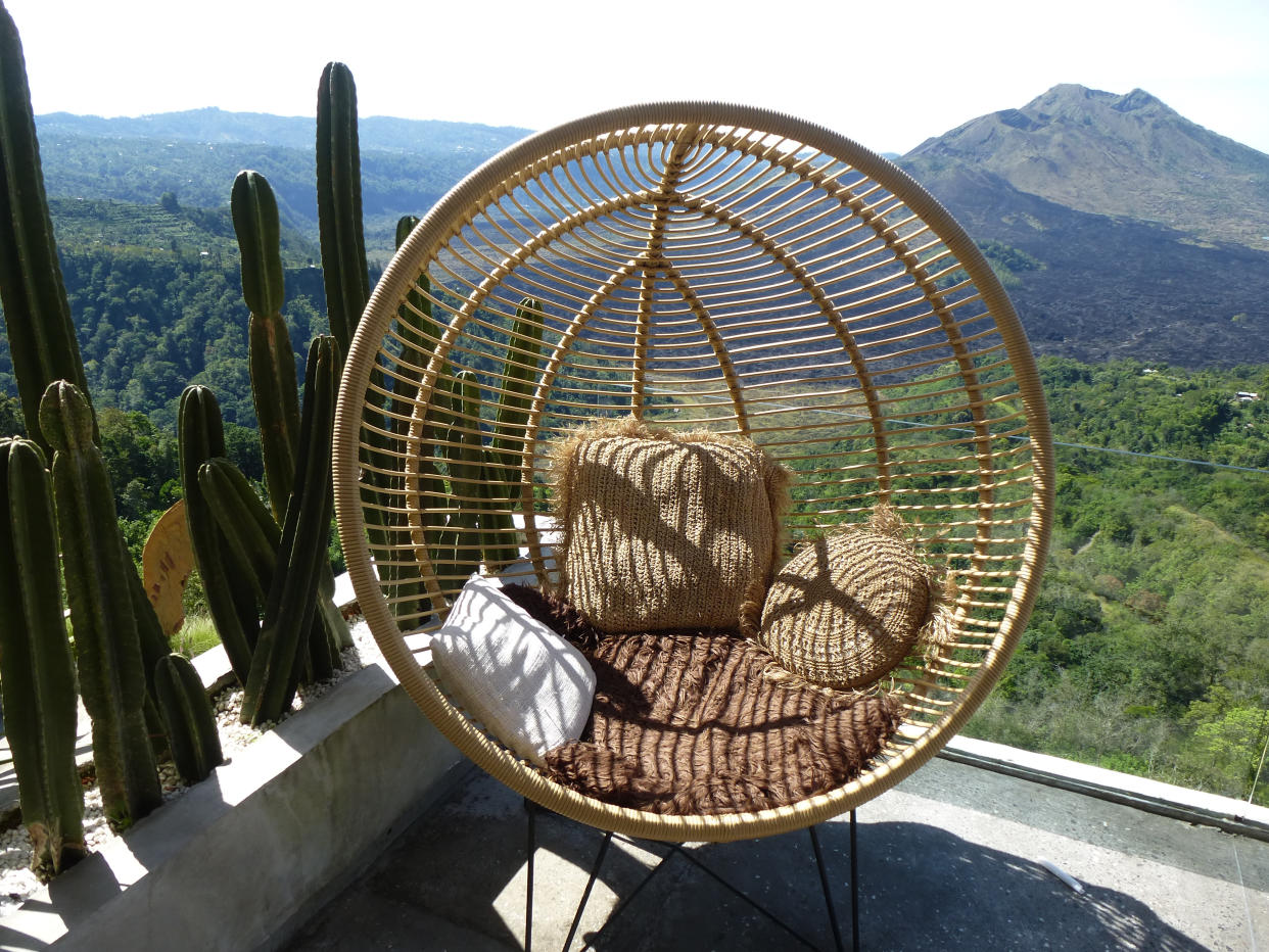 Round egg chair. Wood chair with nature view. Chair  in the balcony