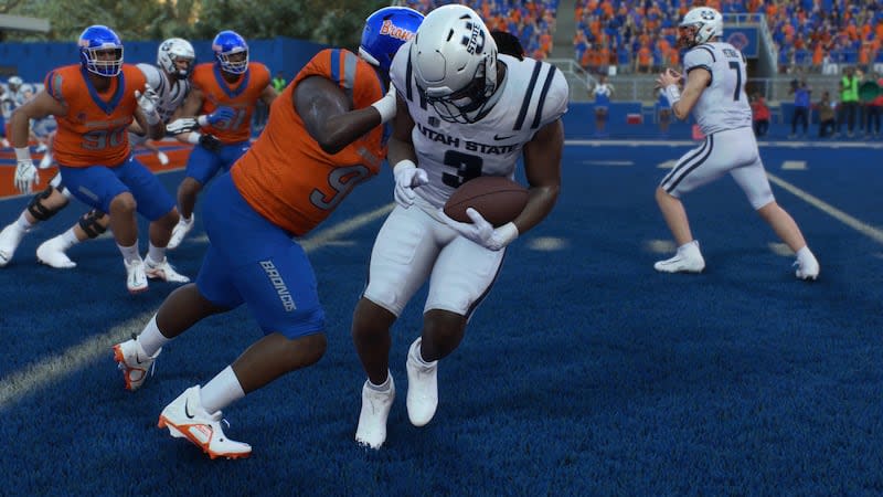 Utah State running back Rahsul Faison is stopped for a loss on fourth-and-goal by Boise State's Herbert Gums during a simulated game between Utah State and Boise State in the EA Sports College Football 25 video game. | EA Sports College Football 25