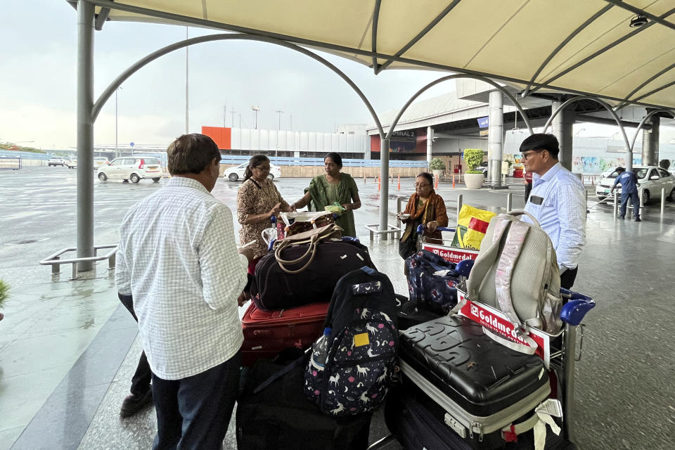 A group of passengers wait after their Go First flight was cancelled at Indra Gandhi International Airport in New Delhi, India, Wednesday, May 3, 2023. Thousands of travelers have been stranded after no-frills Indian air carrier Go First filed for bankruptcy and suspended its flights for three days, starting Wednesday. (AP Photo/Piyush Nagpal)