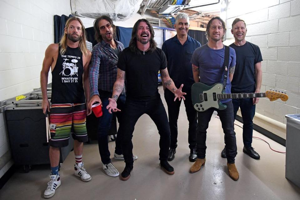 Taylor Hawkins, Rami Jaffee, Dave Grohl, Pat Smear, Chris Shiflett, and Nate Mendel pose backstage as The Foo Fighters in 2021