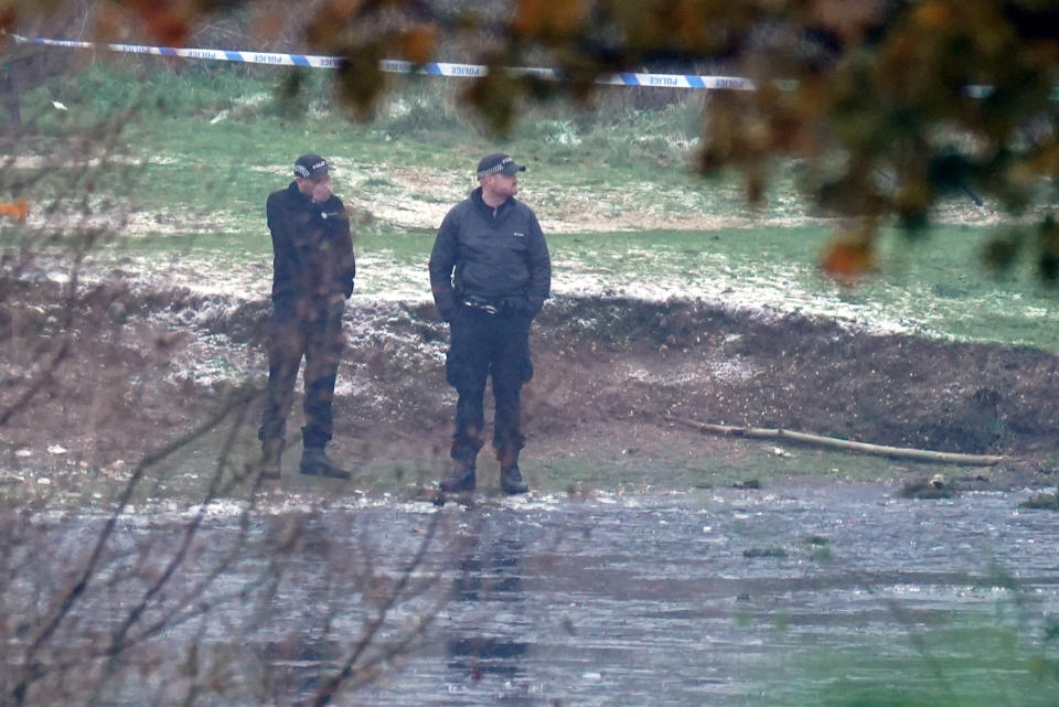 Police officers at the scene in Babbs Mill Park in Kingshurst, Solihull. Four children are in critical condition in hospital after being pulled from an icy lake in cardiac arrest, while a search operation continues amid fears two more children were involved in the incident. Picture date: Monday December 12, 2022.