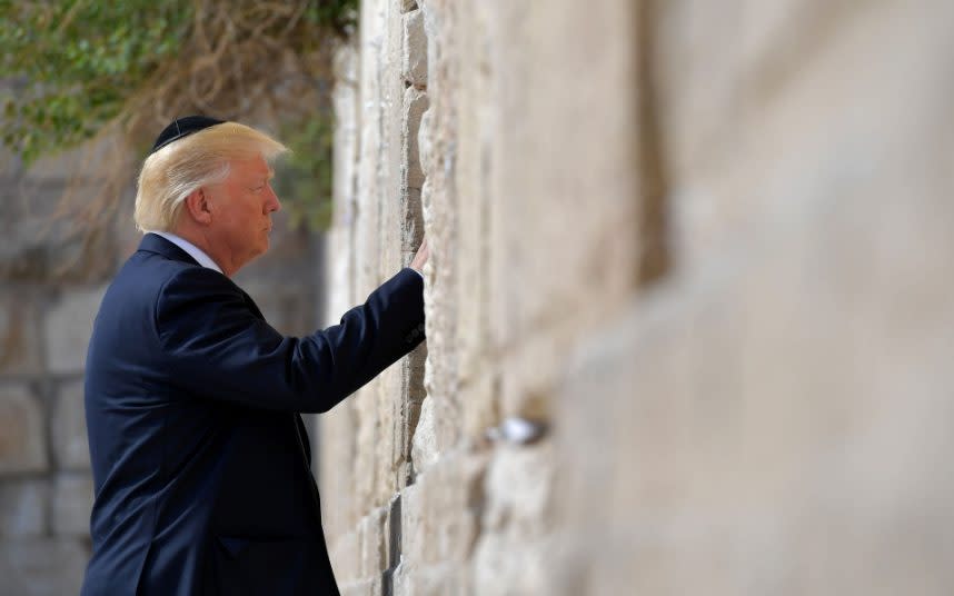 US president Donald Trump visits the Western Wall, the holiest site where Jews can pray, in Jerusalem's Old City - Credit:  MANDEL NGAN/AFP