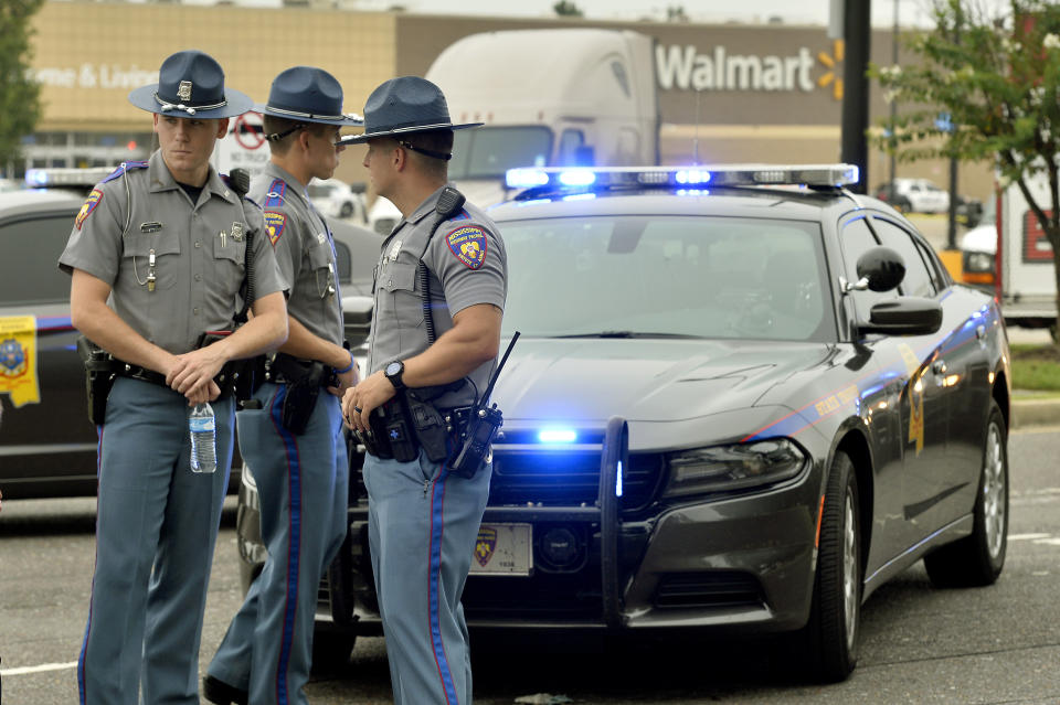 Officers stand at the scene of a shooting inside a Walmart store Tuesday, July 30, 2019 in Southaven, Miss. (AP Photo/Brandon Dill)