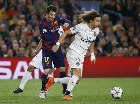 Football - FC Barcelona v Paris St Germain - UEFA Champions League Quarter Final Second Leg - Nou Camp, Barcelona - Spain - 21/4/15 Barcelona's Lionel Messi in action with PSG's David Luiz Reuters / Paul Hanna