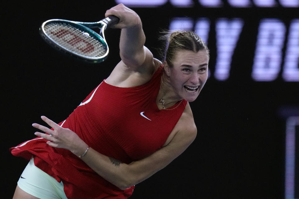 Aryna Sabalenka of Belarus serves to Zheng Qinwen of China during the women's singles final at the Australian Open tennis championships at Melbourne Park, Melbourne, Australia, Saturday, Jan. 27, 2024. (AP Photo/Andy Wong)