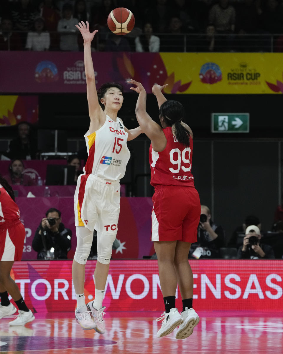 China's Han Xu, left, attempts to block a shot from Japan's Monica Okoye during the Asia Cup women's basketball final in Sydney, Australia, Sunday, July 2, 2023. (AP Photo/Mark Baker)