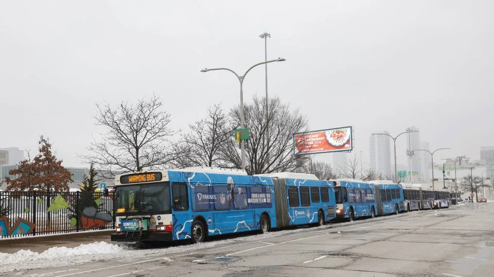Chicago Transit Authority warming buses sit at the migrant landing zone during extreme, cold temperatures on Friday. - Kamil Krzaczynski/AFP via Getty Images