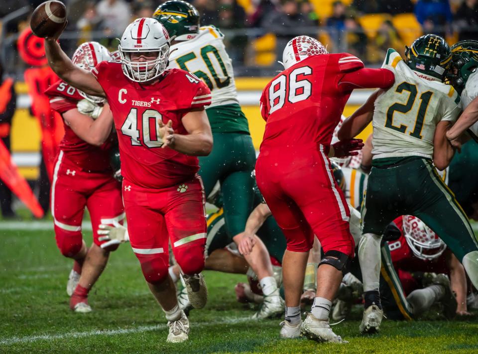 Moon's Ben Bladel runs around the pile and into the end zone late in the second quarter against Penn-Trafford during the WPIAL 5A Championship Saturday at Heinz Field.[Lucy Schaly/For BCT]