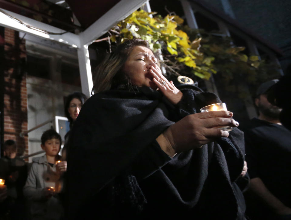 Chef Priscila Satkoff fights back tears during a candlelight memorial for Chicago Chef Charlie Trotter outside Trotter's former restaurant Tuesday, Nov. 5, 2013, in Chicago. Trotter, 54, died Tuesday, a year after closing his namesake Chicago restaurant that was credited with putting his city at the vanguard of the food world and training dozens of the nation's top chefs, including Grant Achatz and Graham Elliot. (AP Photo/Charles Rex Arbogast)