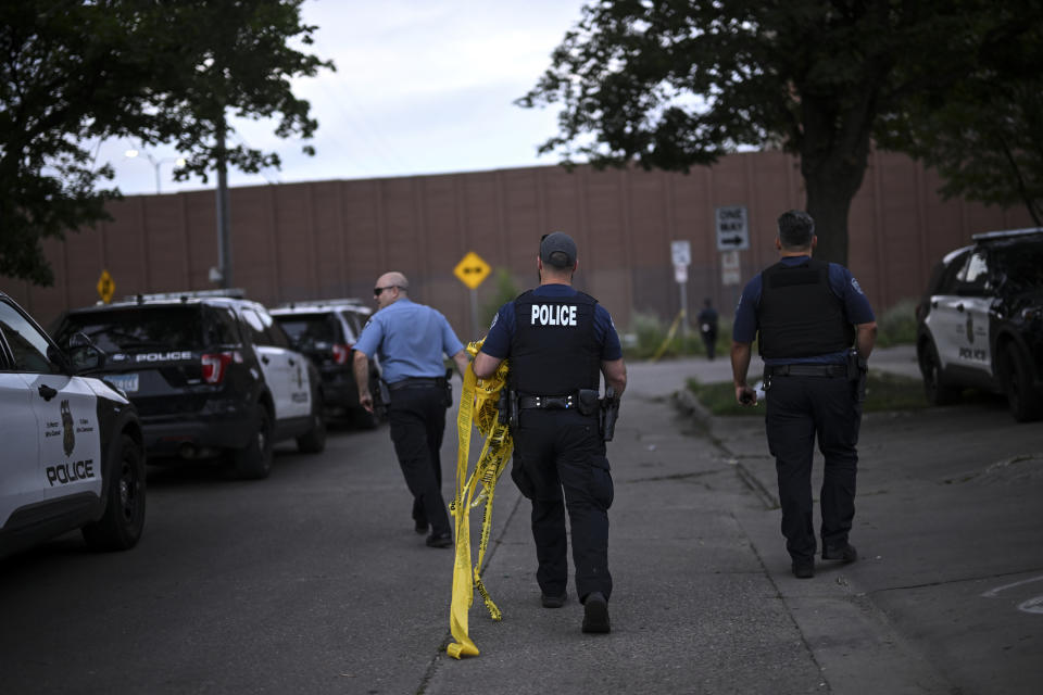 Minneapolis police officers leave the scene before a vigil for 20-year-old was held Thursday, July 14, 2022, outside the apartment building where he was killed by police in Minneapolis. Police fatally shot the man early Thursday, ending an hourslong standoff that began with a shooting before officers arrived, officials said. Authorities negotiated with the man for about six hours before police shot him, said Minneapolis Police Department spokesman Garrett Parten. He was taken to a hospital and died, officials said. (Aaron Lavinsky/Star Tribune via AP)