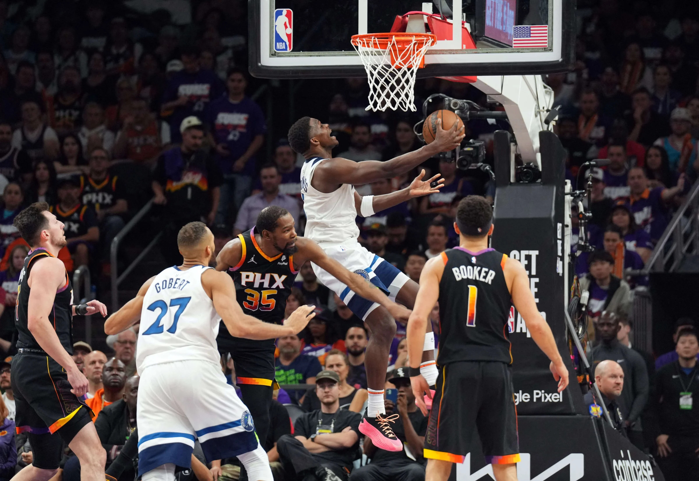 Apr 26, 2024; Phoenix, Arizona, USA; Minnesota Timberwolves guard Anthony Edwards (5) puts up a layup against the Phoenix Suns during the second half of game three of the first round for the 2024 NBA playoffs at Footprint Center. Mandatory Credit: Joe Camporeale-USA TODAY Sports