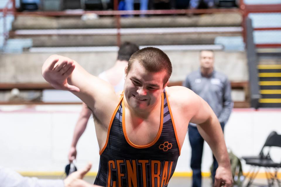 Central York's Michael Wolfgram slaps his coach's hand  after defeating Dallastown's Raymond Christas during a 285-pound championship bout at the District 3 wrestling championships at Hersheypark Arena Saturday, February 23, 2019. Wolfgram won by tech fall 24-9 5:08. 