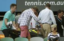 Nigel Sears, coach of Serbia's Ana Ivanovic, is carried away on a stretcher after he collapsed during Ivanovic's third round match against Madison Keys of the U.S., causing play to be suspended, at the Australian Open tennis tournament at Melbourne Park, Australia, January 23, 2016. REUTERS/Brandon Malone