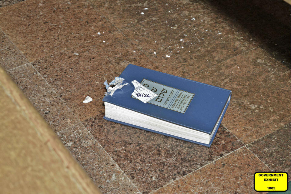 This image released by the Department of Justice. shows a bullet-damaged prayer book that was introduced as a court exhibit, Tuesday, May 30, 2023, in the federal trial of Robert Bowers in Pittsburgh, Bowers went on trial Tuesday more than four years after an attack on a Pittsburgh synagogue that killed 11 worshippers and wounded 7 others. Tree of Life Rabbi Jeffrey Myers testified Tuesday that the book serves as a “witness to the horror of that day.” (Department of Justice via AP)