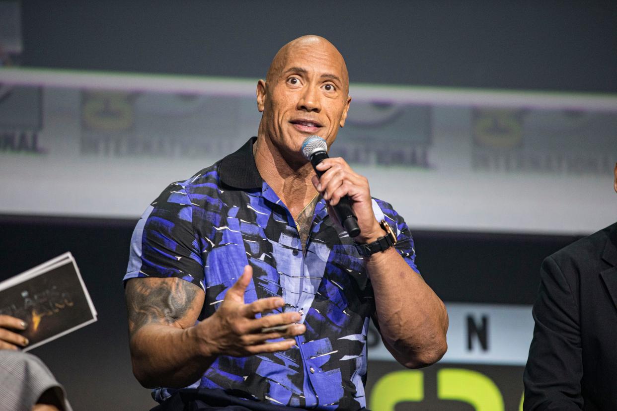 Dwayne Johnson on stage at the Warner Bros. panel promoting "Black Adam" at San Diego Comic-Con.