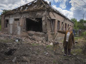 Local resident Tetyana points at her house heavily damaged by the Russian shelling in Bakhmut, Donetsk region, Ukraine, Friday, June 24, 2022.(AP Photo/Efrem Lukatsky)