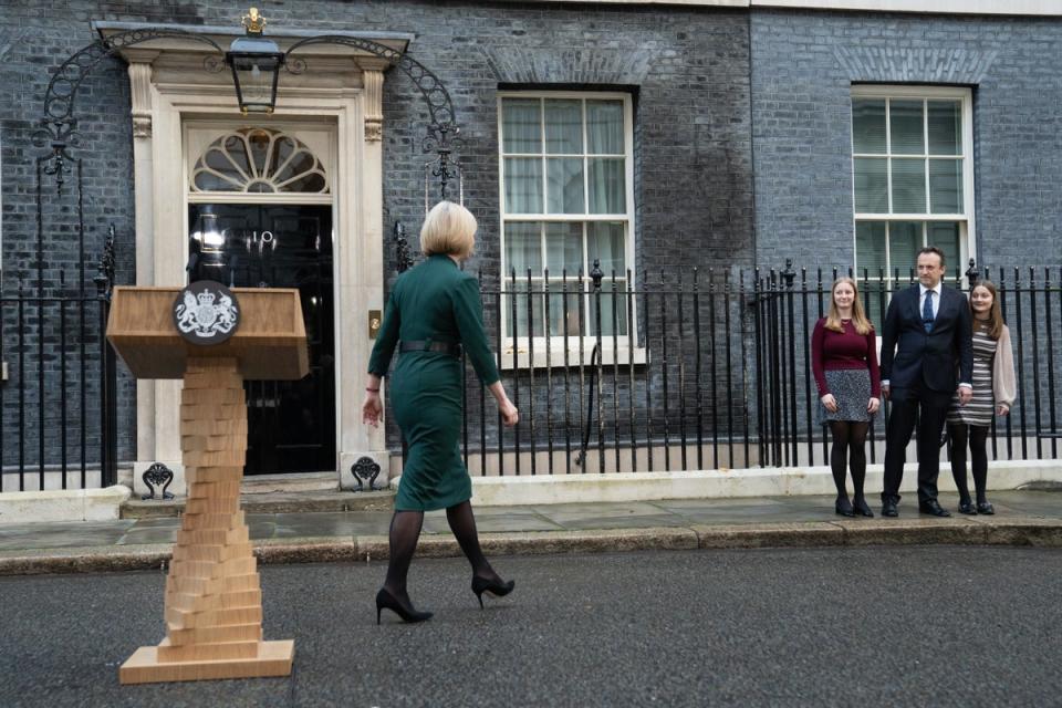 Outgoing prime minister Liz Truss joins her family after addressing the media outside 10 Downing Street, and saying she would resigining as PM (PA)