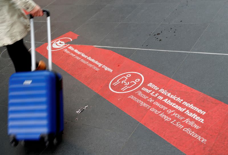 FILE PHOTO: A social distancing floor sign is seen at the main train station Hauptbahnhof, as the spread of the coronavirus disease (COVID-19) continues, in Berlin