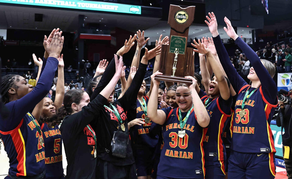 Purcell Marian celebrates its third championship in a row after beating Laurel in the OHSAA DII state final Saturday, March 16, 2024.