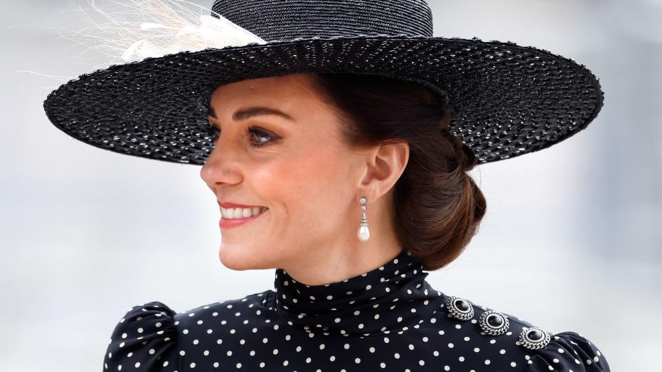 Princess Kate wearing black and white polka dots and a hat