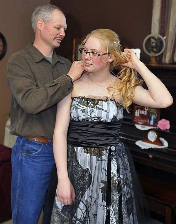 <div class="caption-credit"> Photo by: Casey Lake/News-Herald Media</div><div class="caption-title">The Dad Who Sewed His Daughter's Prom Dress</div>The Dad Who Wore A Skirt for his SonWhen 17-year-old Mariah Herron of Marshfield, Wisconsin, couldn't find her prom dress of her dreams, her dad made one for her. From scratch. Out of camouflage. "My daughter loves to hunt and fish and be outdoors and she really wanted a camo prom dress," Herron told Yahoo! Shine. "We looked online and everything was so expensive. So I suggested that we go to a fabric store to look at patterns." He ended up sewing the dress himself, creating a strapless Snow White Camouflage gown with a delicate black tulle overlayer and a black satin sash. She, of course, loves it. Read the whole story: <a rel="nofollow" href="http://shine.yahoo.com/parenting/military-dad-makes-daughter-s-prom-dress--it-s-camo-191228290.html" data-ylk="slk:Military Dad Makes His Daughter a Camo Prom Dress;elm:context_link;itc:0;sec:content-canvas;outcm:mb_qualified_link;_E:mb_qualified_link;ct:story;" class="link  yahoo-link">Military Dad Makes His Daughter a Camo Prom Dress</a> <br>