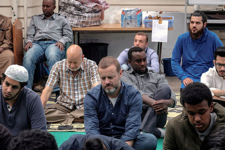 Australian journalist Dean Yates sits with Muslims as they pray at the Elsedeaq Heidelberg Mosque, located in the Melbourne suburb of Heidelberg in Australia, March 2, 2018. Picture taken March 2, 2018. REUTERS/Luis Enrique Ascui