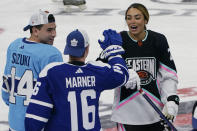 Montreal Canadiens' Nick Suzuki (14) and Toronto Maple Leafs' Mitchell Marner (16) congratulate Canadian hockey player Sarah Nurse after she scored a goal during the NHL All Star Skills Showcase, Friday, Feb. 3, 2023, in Sunrise, Fla. (AP Photo/Marta Lavandier)