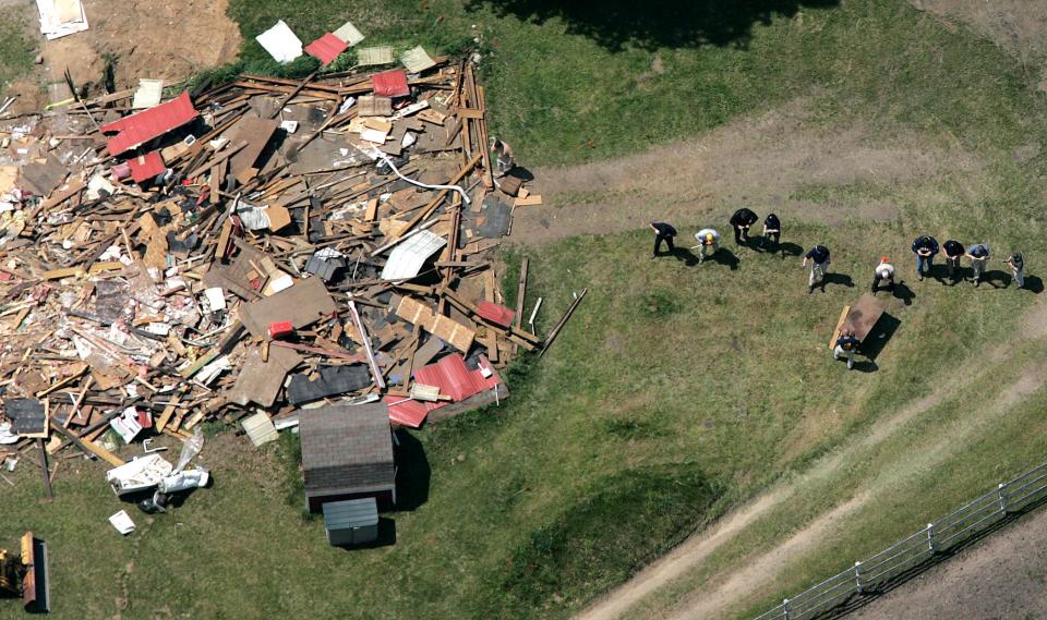 In this May 24, 2006, file photo, workers, including Federal Bureau of Investigation evidence response team members, probe the ground near a demolished barn at a horse farm in Milford Township, Mich., where FBI agents investigating Jimmy Hoffa's 1975 disappearance. The FBI's recent confirmation that it was looking at a spot near a New Jersey landfill as the possible burial site of former Teamsters boss Jimmy Hoffa is the latest development in a search that began when he disappeared.