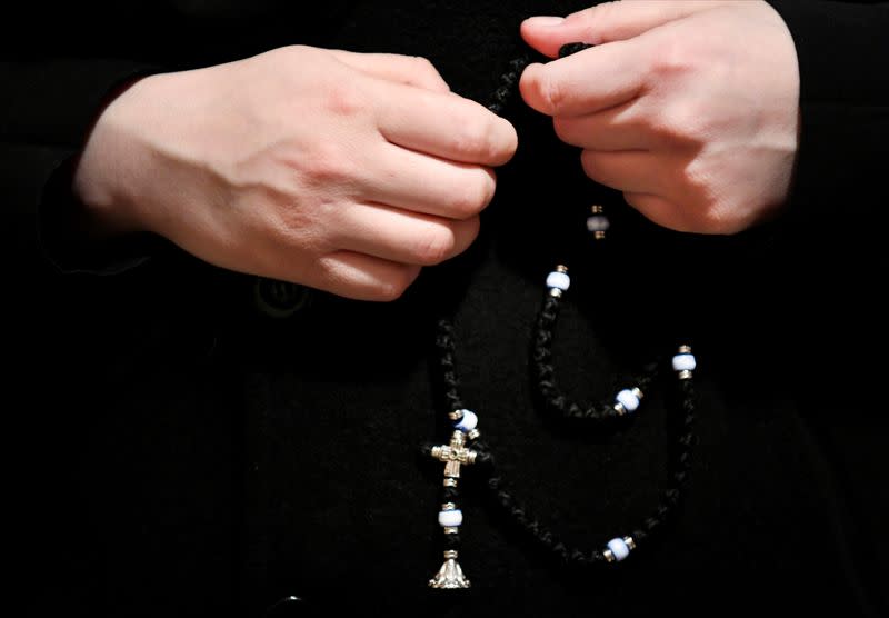 A nun holds her prayer chain on a mobile Georgian Orthodox monastery in Vlissingen