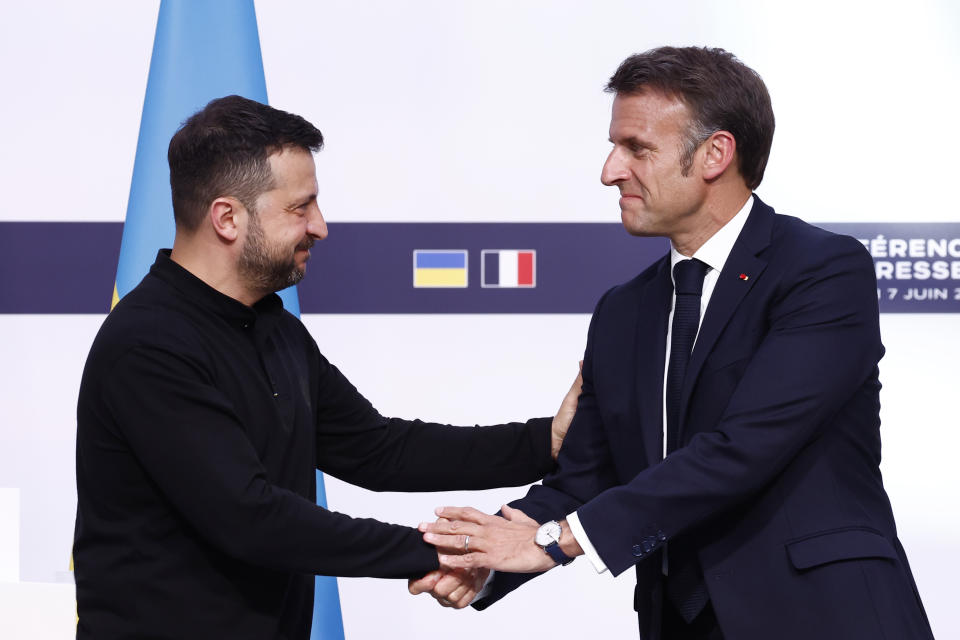 French President Emmanuel Macron, right, shakes hands with Ukrainian President Volodymyr Zelenskyy during a joint press conference, Friday, June 7, 2024 at the Elysee Palace in Paris. U.S. President Joe Biden was due to meet with Ukrainian President Volodymyr Zelenskyy in Paris on Friday as Kyiv's army endures its hardest days of fighting since the early weeks of the war with Russia and prepares for what officials say could be a tough summer ahead. (Yoan Valat, Pool via AP)