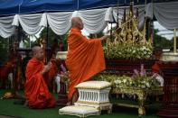 <p>A monk lights a candle at an altar during a Buddhist prayer for the missing children near Tham Luang cave at the Khun Nam Nang Non Forest Park in Chiang Rai Province on July 1, 2018. (Photo: Lillian Suwanrumpha/AFP/Getty Images) </p>