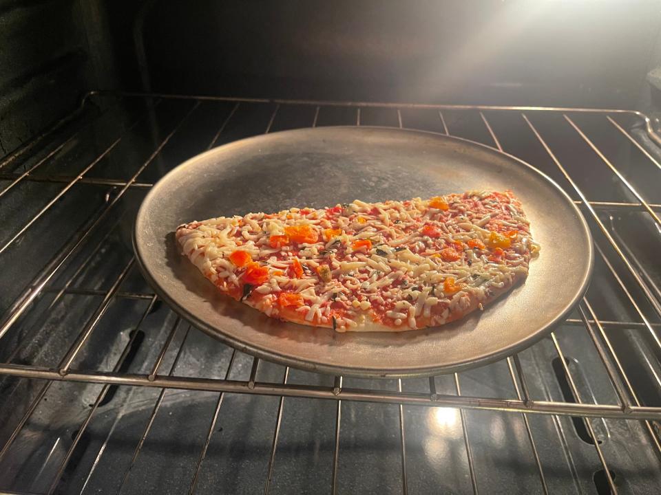 Pizza baking in oven