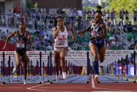 Anna Cockrell, right, wins the fourth heat of the women's 100-meter hurdles at the U.S. Olympic Track and Field Trials Saturday, June 19, 2021, in Eugene, Ore. (AP Photo/Ashley Landis)