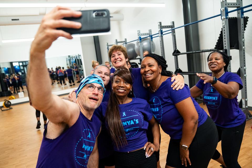 Other students in her Zumba class embrace Keenya Taylor as they take a selfie after class.