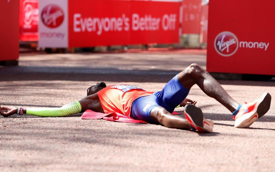 Mo Farah lies on the floor at the finish with exhaustion - REUTERS