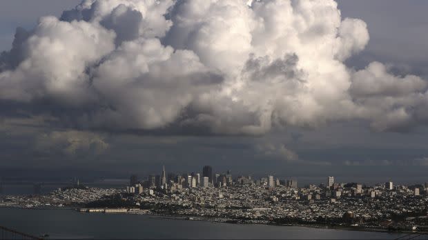 A large cloud gathers over the skyline of San Francisco