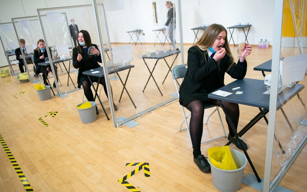 Pupils at a school in Coulsdon, Surrey, take Covid tests as the children of key workers returned to school earlier this year -  Aaron Chown/PA