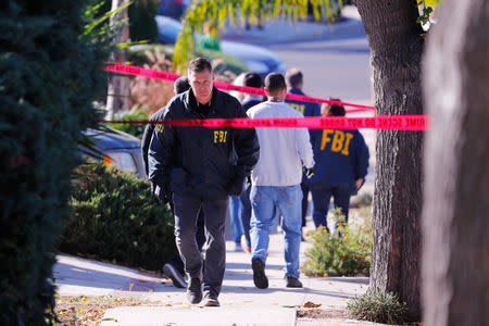 Police and FBI officers wait outside the home of the suspect in a shooting incident at a Thousand Oaks bar, in Newbury Park, California, U.S. November 8, 2018. REUTERS/Mike Blake