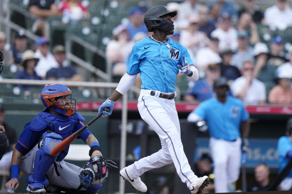 Miami Marlins' Jazz Chisholm Jr., right, watches after hitting a single during the third inning of a spring training baseball game against the New York Mets, Monday, March 13, 2023, in Jupiter, Fla. (AP Photo/Lynne Sladky)