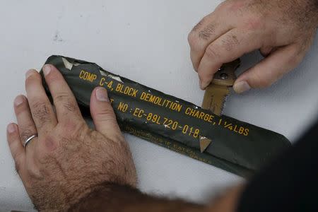 An expert from the U.S. Bureau of Alcohol, Tobacco, Firearms and Explosives (ATF) opens a C-4 package to prepare an improvised explosive device (IED), which will be detonated during a course on blast scene investigation, near Hua Hin, Thailand January 17, 2016. REUTERS/Jorge Silva