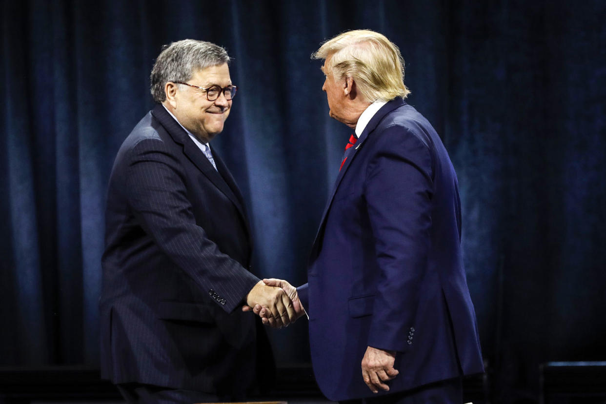 President Donald Trump shakes hands with Attorney General William Barr on Oct. 28, 2019, in Chicago. (Charles Rex Arbogast / AP file)