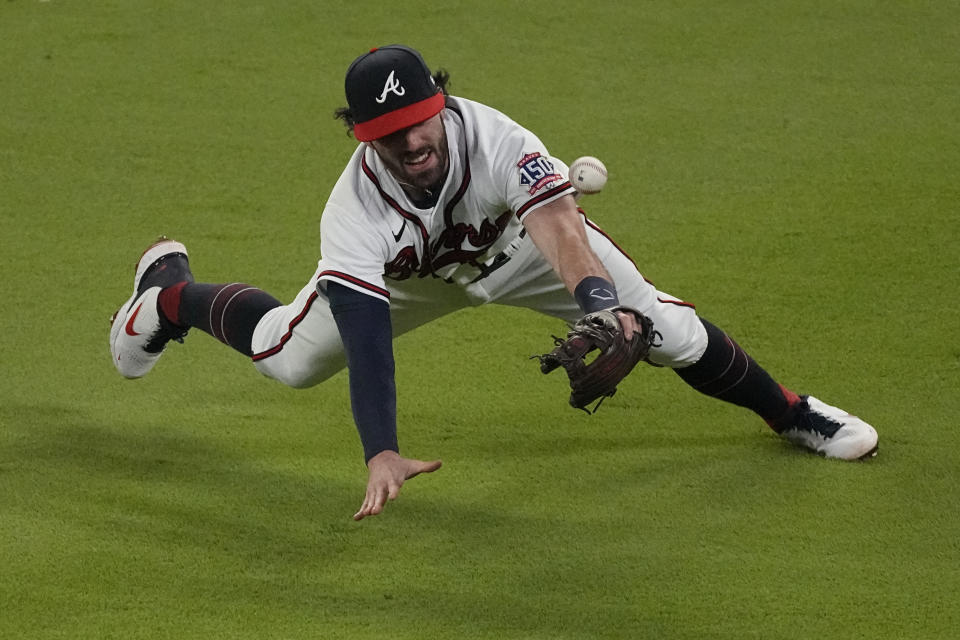 Atlanta Braves shortstop Dansby Swanson can not make the play on a single by Los Angeles Dodgers' Mookie Betts during the first inning in Game 2 of baseball's National League Championship Series Sunday, Oct. 17, 2021, in Atlanta. (AP Photo/John Bazemore)