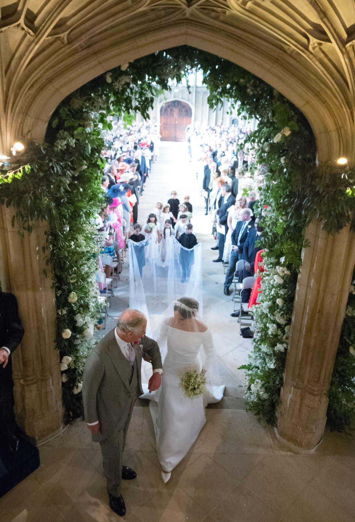 Meghan walks up the aisle with Prince Charles, the Prince of Wales. 