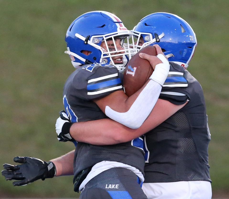 Matthew Sollberger, left, of Lake celebrates his touchdown with Stiles Diesz during their home game against GlenOak on Friday, Sept. 9, 2022.